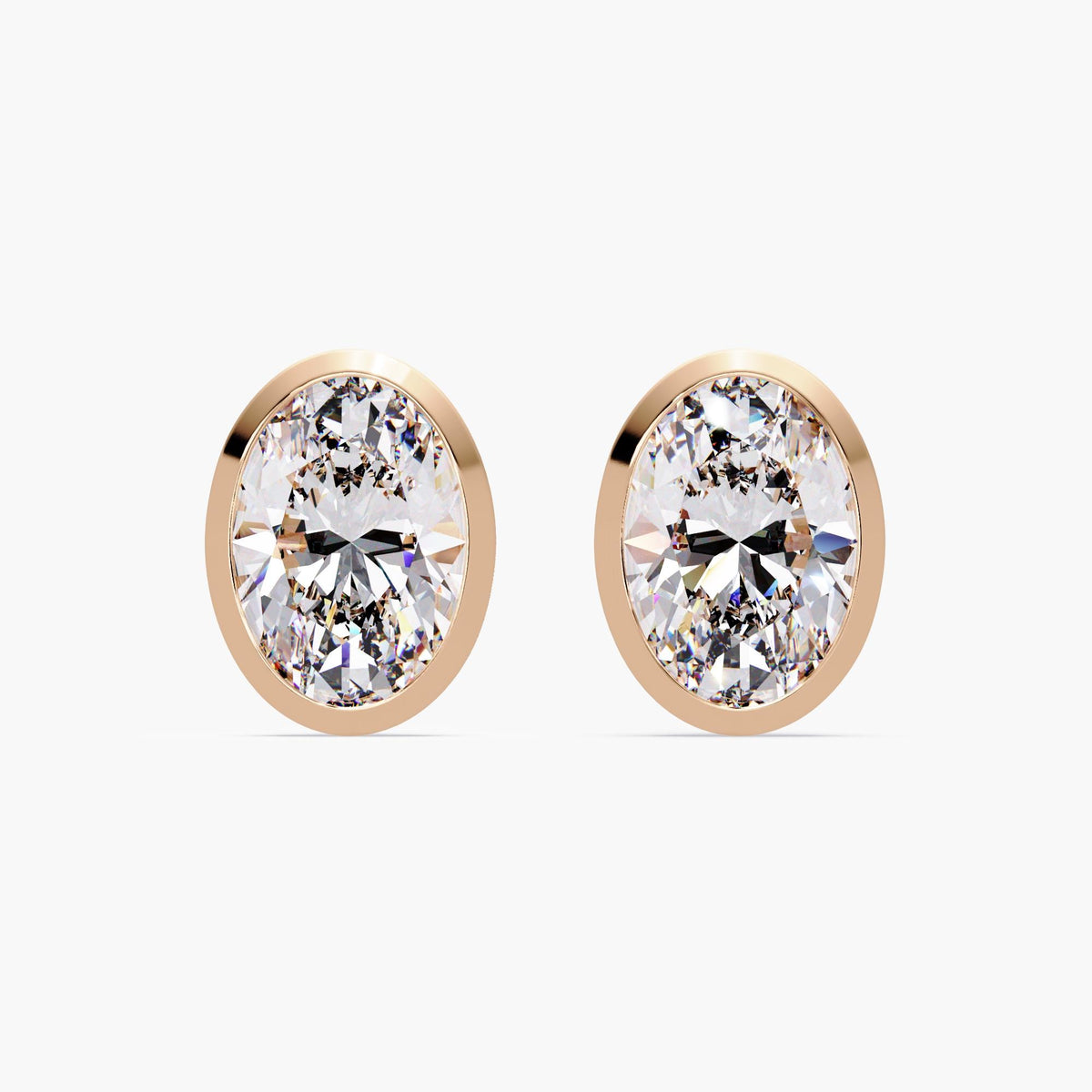 14k rose gold bezel set oval diamond stud earring, showcasing the low-profile open gallery and straight pushback post. Designed for secure and comfortable everyday wear.