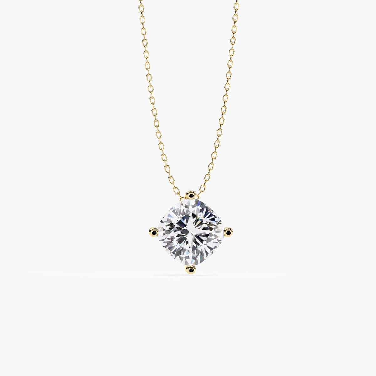 Front view of a cushion cut lab-grown diamond pendant set in a four-prong 14k yellow gold setting, hanging from a fine cable chain.