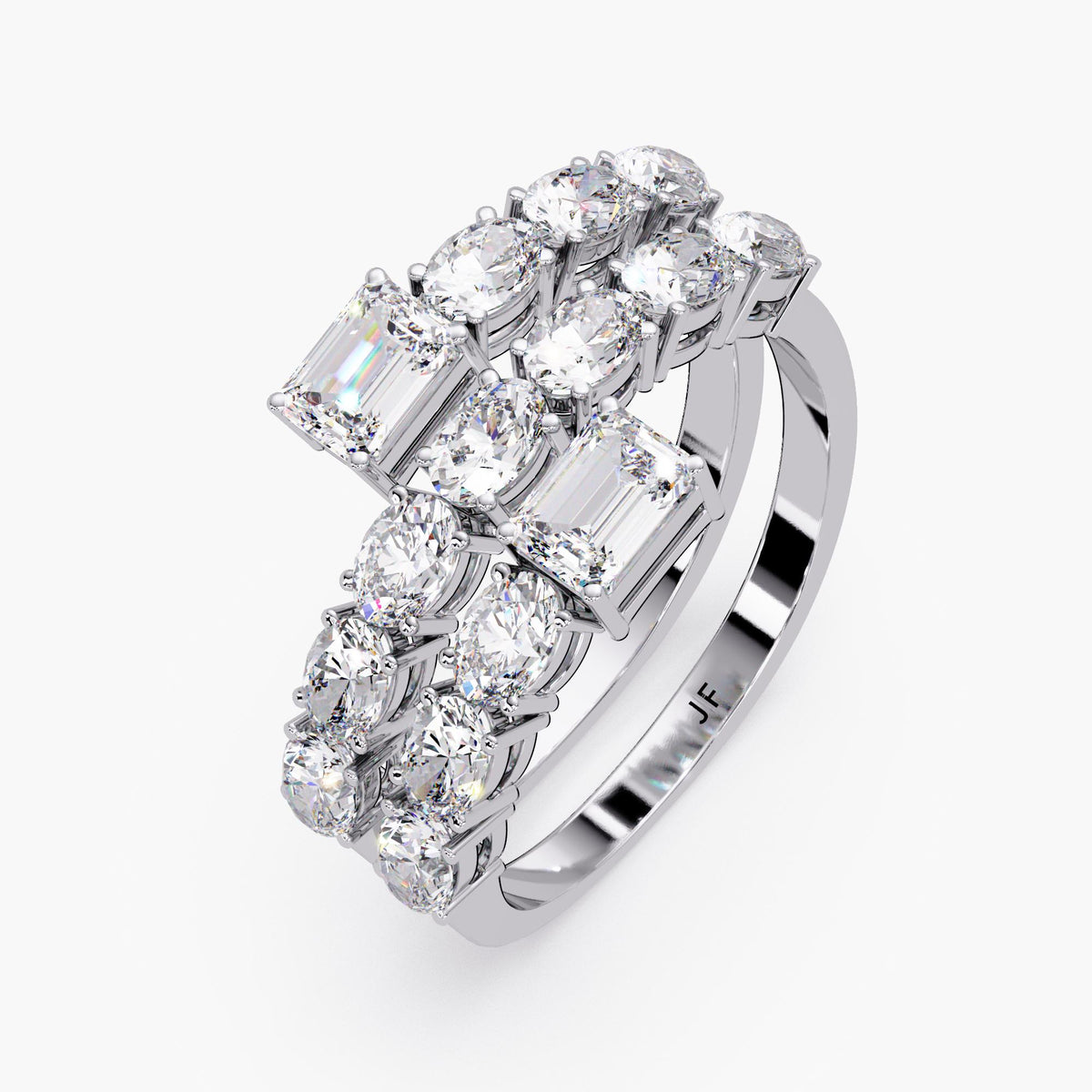 A close-up view of a three-row spiral wrap ring in white gold, showcasing two emerald cut diamonds at each open end. The band is set with multiple oval diamonds in a half eternity style, creating a layered bypass silhouette that curves fluidly around the finger.