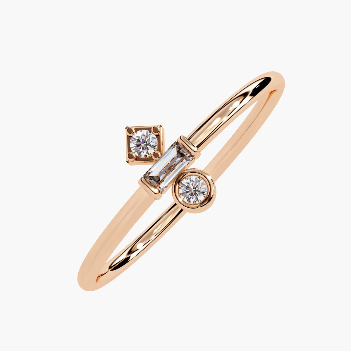 Angled view of a 14k rose gold ring showcasing three lab-grown diamonds in an open geometric design. The ring features a square-set round diamond, a horizontal baguette diamond, and a bezel-set round diamond. The soft rose gold finish and asymmetrical layout create a delicate, contemporary look, perfect for everyday wear or stacking.