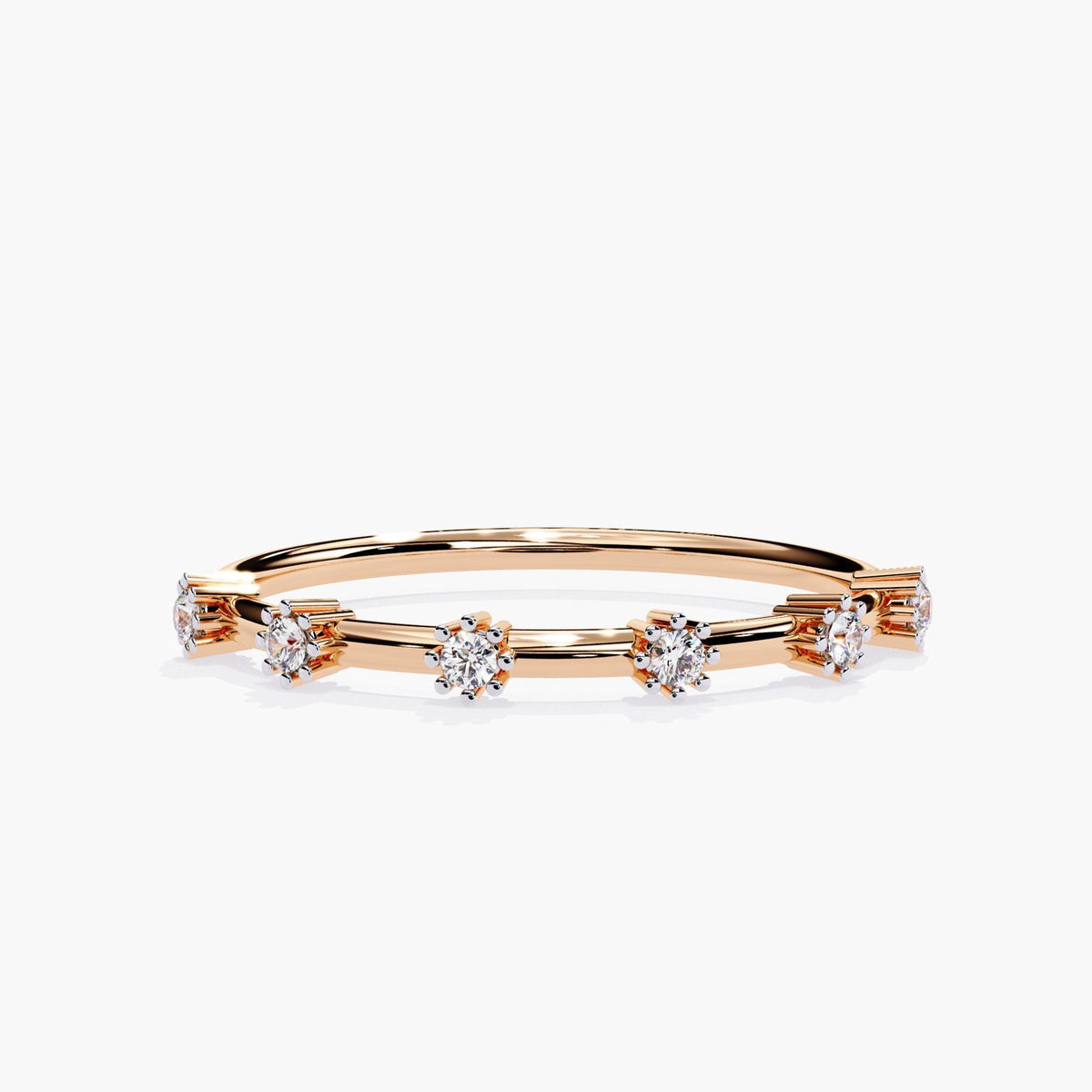 Front view of a 14k rose gold distance diamond band with six round natural diamonds set in raised claw prongs. The slim 1.3mm band creates space between each 1.5mm diamond, giving a floating effect for a delicate and modern half eternity look.