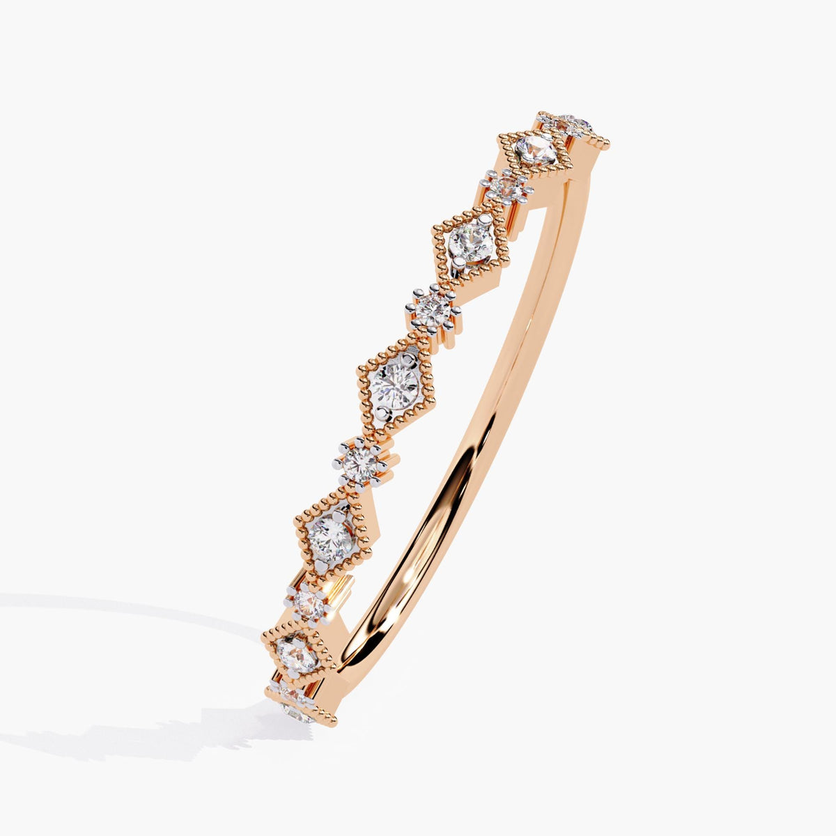 Angled view of a 14k rose gold half eternity diamond ring featuring lab-grown round diamonds in alternating prong and milgrain marquise settings. The slim band highlights the vintage Art Deco design and soft rose tone.