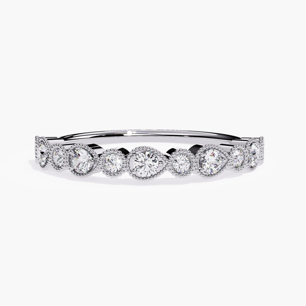 "A white gold stackable eternity band featuring alternating round and pear-shaped bezel-set diamonds, each encircled by fine milgrain detailing. The diamonds are arranged in a continuous pattern around the band, creating an elegant and timeless design. The polished white gold setting complements the sparkling diamonds, making this ring a perfect choice for stacking with other bands or wearing alone for a sophisticated, vintage-inspired look.