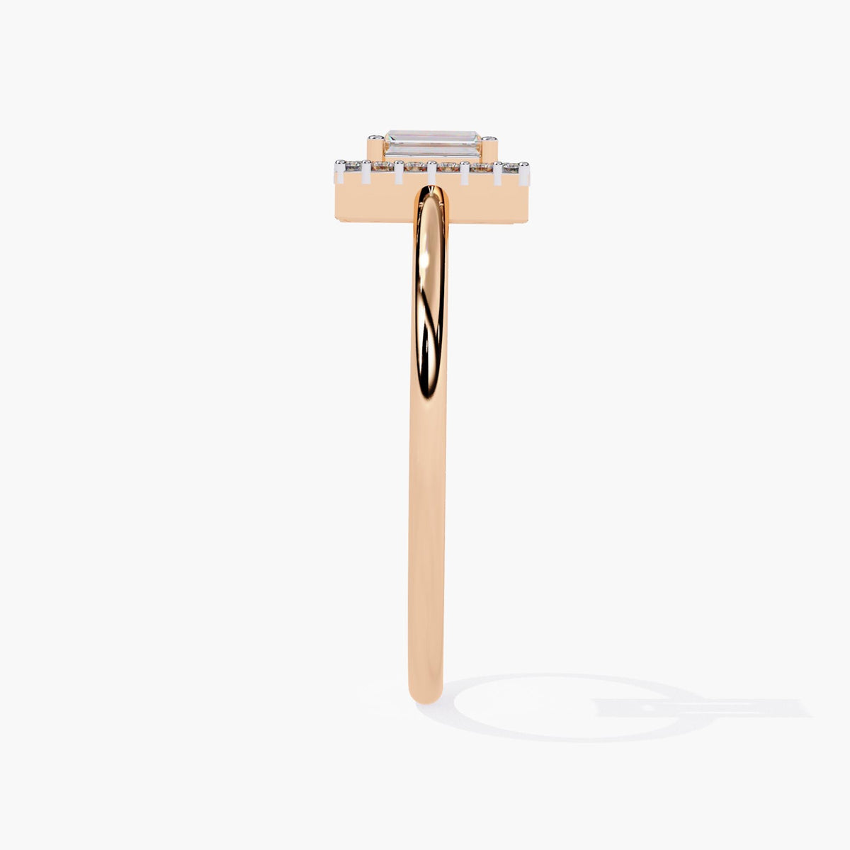 A side view of a rose gold ring showcasing a rectangular emerald-cut diamond, set in a sleek band. The diamond is framed by a halo of round brilliant diamonds, adding extra sparkle. The clean, minimalistic design highlights the elegant simplicity of the piece, while the polished rose gold band offers a warm, refined contrast. This timeless piece is perfect as an engagement ring or a classic statement piece.