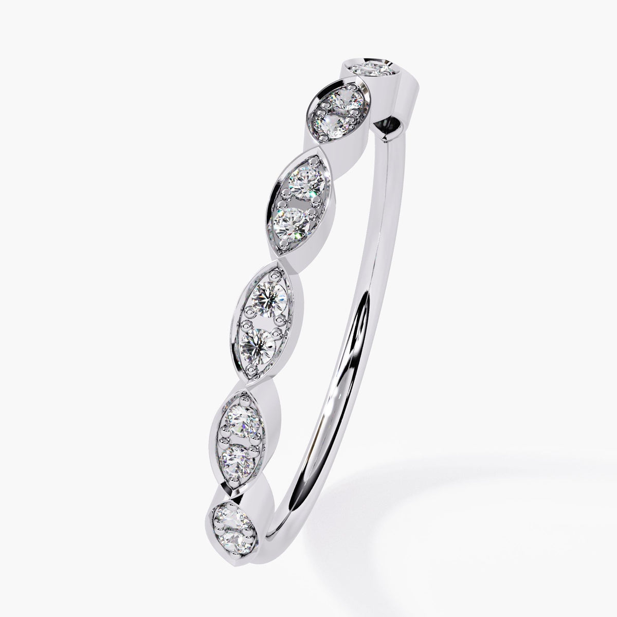 "A white gold ring featuring alternating marquise-shaped settings with round diamonds. The diamonds are surrounded by a delicate halo, creating a stunning and elegant look. The clean, polished band complements the intricate diamond arrangement, making this piece perfect for stacking or as a standalone wedding band, promise ring, or anniversary gift.