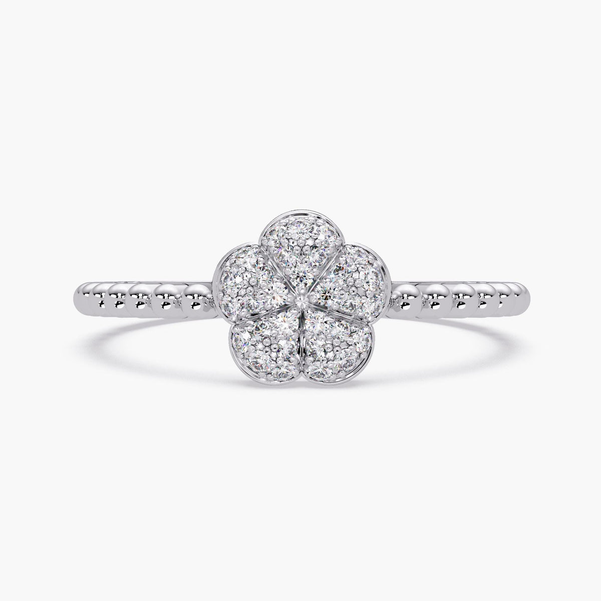 14k white gold ring featuring a pavé diamond floral centerpiece with five softly domed petals. Each petal is outlined in polished gold and filled with round-cut diamonds for a clustered sparkle. The band is beaded along the top half, adding texture to the sleek, cool-toned setting.