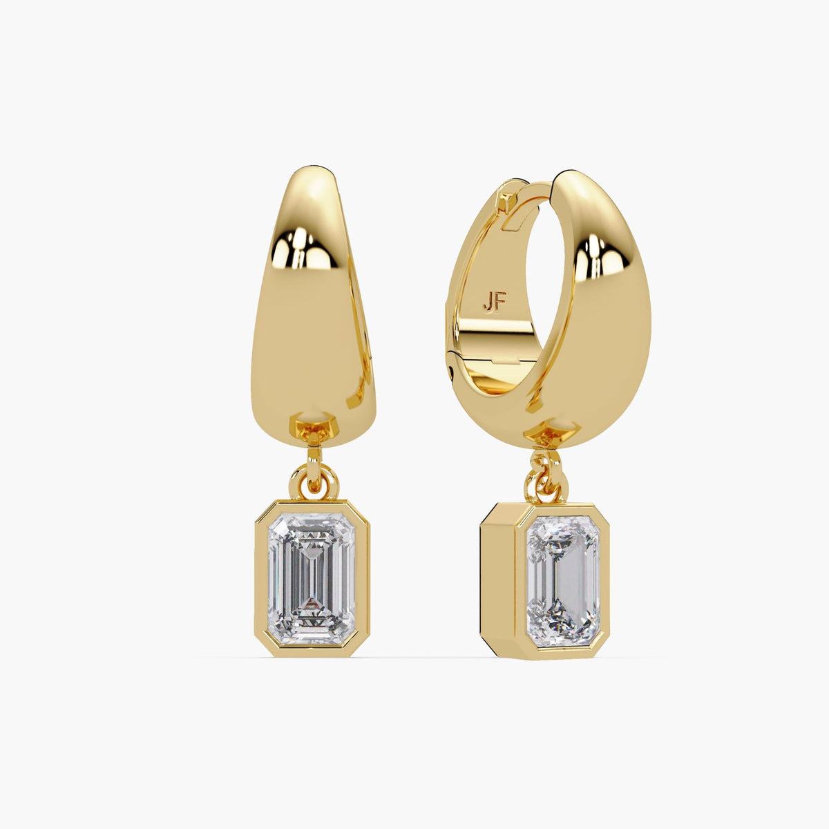 These are dainty, minimalist huggie hoop earrings crafted in 14K gold. Each hoop measures 15mm, making them a comfortable medium-sized option for everyday wear. The design features a secure leverback closure and a sleek, polished finish. Suspended from each hoop is a teardrop-style charm set with an emerald cut lab-grown diamond in a bezel setting. The emerald diamonds add just the right touch of sparkle while maintaining a refined and understated look