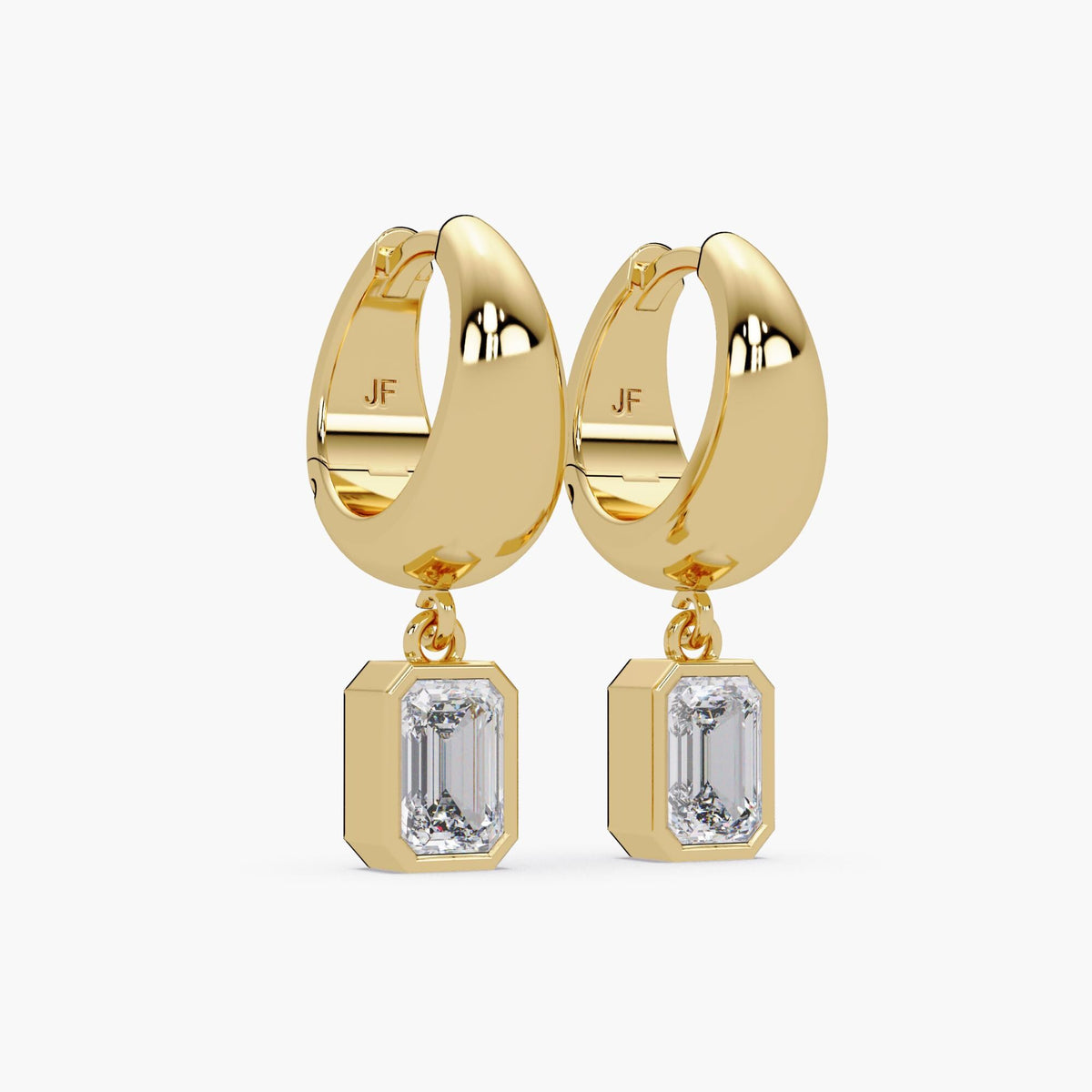 These dainty 15mm huggie hoop earrings are crafted in polished 14K gold with a minimalist leverback design. Each hoop features a bezel-set emerald cut lab-grown diamond that dangles in a teardrop-inspired charm. The clean lines and soft movement make them a refined yet modern choice for everyday wear or subtle statement styling.