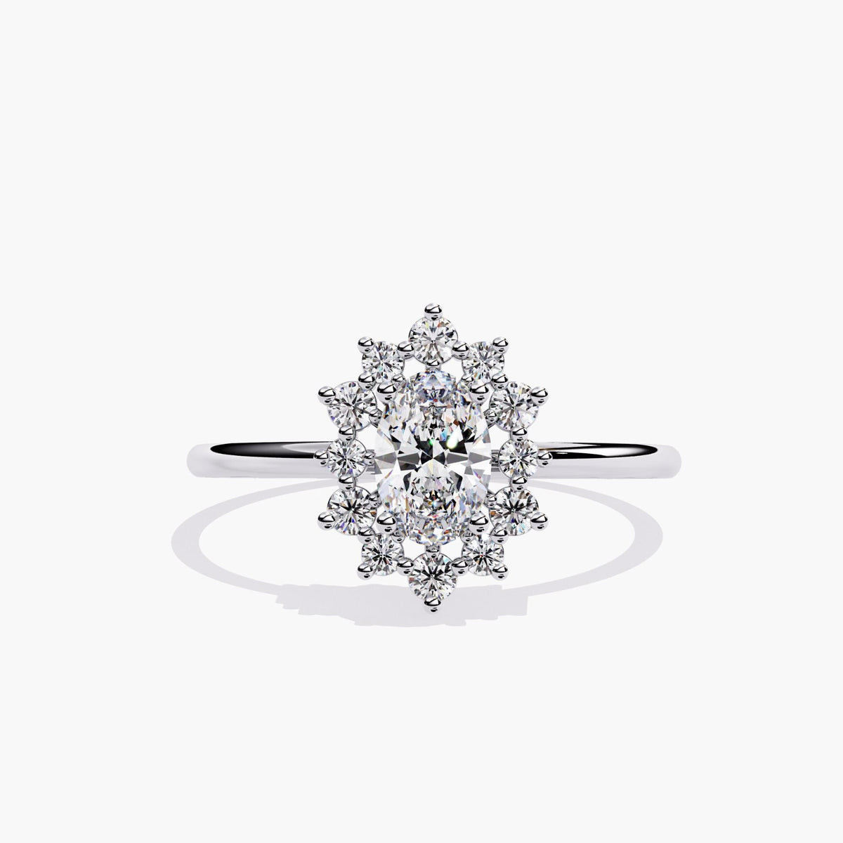 14K white gold ring featuring a 0.5 carat oval lab-grown diamond, framed by a floral starburst halo of small round diamonds. The ring has a polished, thin band and a symmetrical front-facing view.