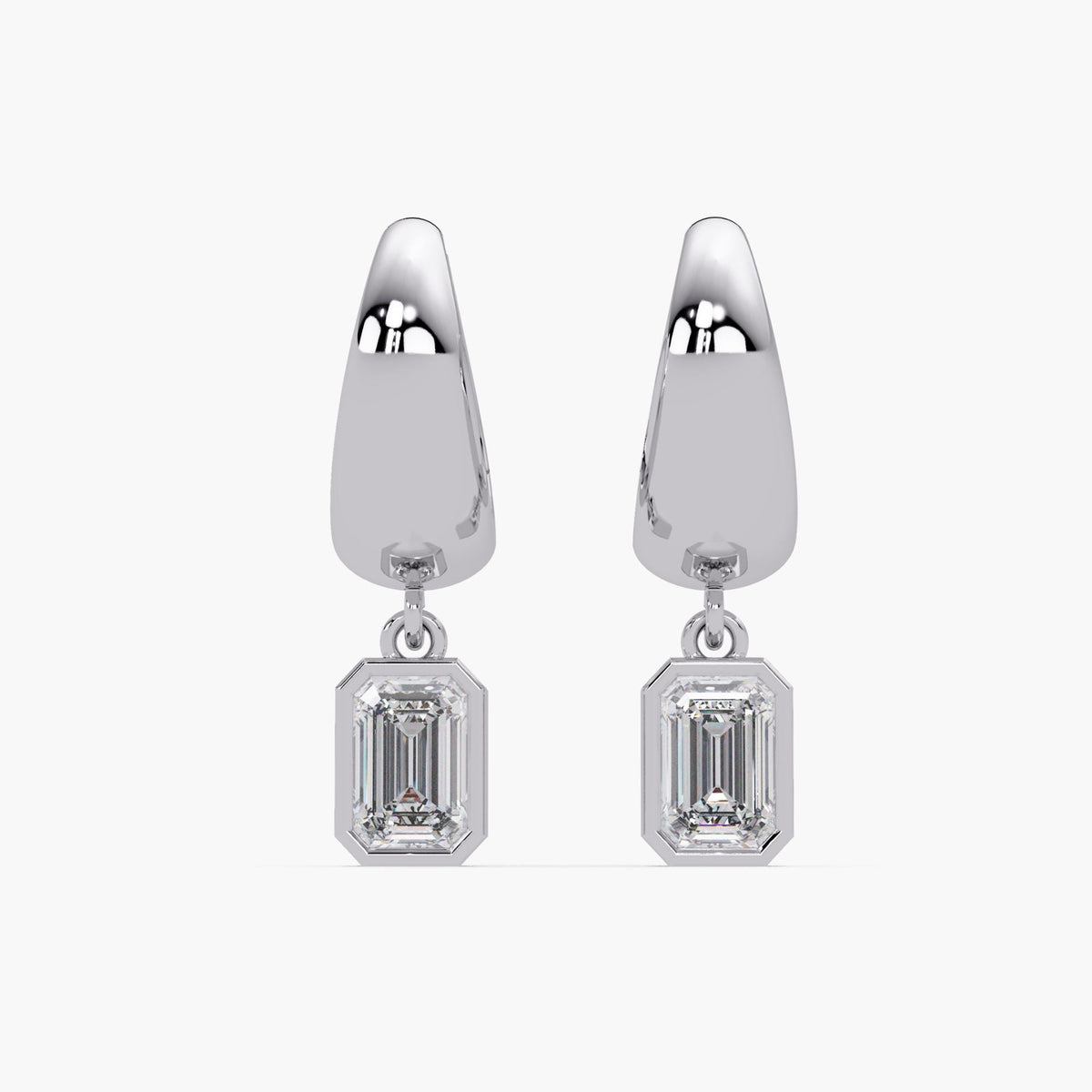 Front view of 15mm white gold huggie hoop earrings with leverback closure, featuring bezel-set emerald cut lab-grown diamond charms. These dainty, minimalist drop earrings offer a sleek teardrop silhouette with a refined, modern shine.