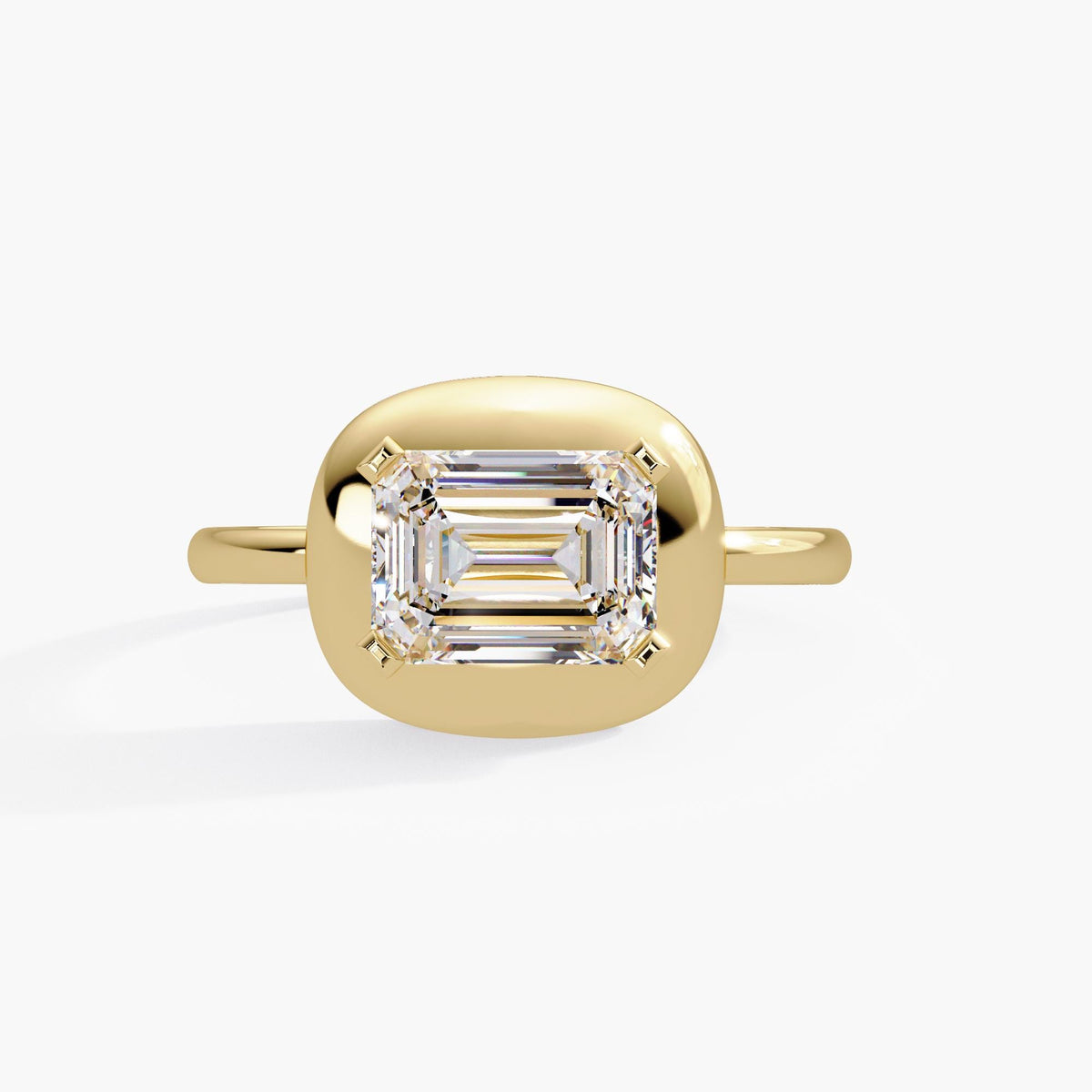East-west emerald cut diamond bezel ring in 14K yellow gold with 1.60 carat IGI-certified lab diamond, bold dome design for modern engagement or statement wear. A meaningful gift for birthdays, anniversaries, or celebrating personal milestones.