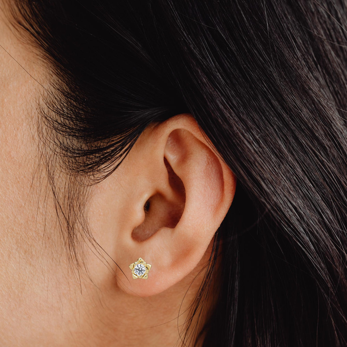 model wearing Floral diamond stud earrings in 14K yellow gold featuring round lab-grown diamonds set in a layered petal design. A gift for birthdays, weddings, or everyday wear. Perfect for weddings and summer style