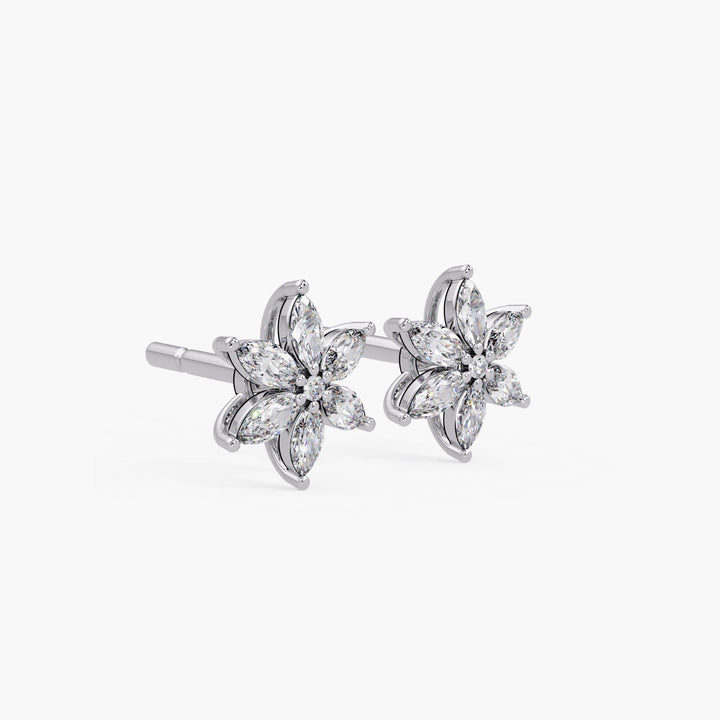 Angled view of white gold marquise diamond flower stud earrings with six marquise-cut diamonds and a round center stone, featuring a secure push-back post and elegant curved setting