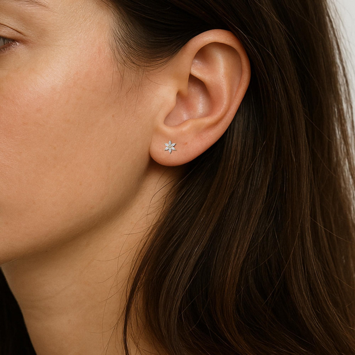 Marquise diamond flower stud earring shown on ear, dainty floral stud in 14K gold with six marquise-cut diamonds, minimalist fit for everyday wear or second piercing