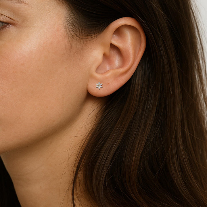 Marquise diamond flower stud earring shown on ear, dainty floral stud in 14K gold with six marquise-cut diamonds, minimalist fit for everyday wear or second piercing