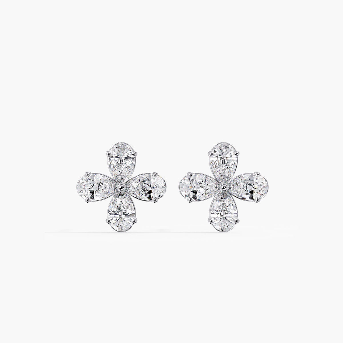 Pair of 14K white gold floral stud earrings featuring four lab-grown pear-shaped diamonds in each earring. The cluster design forms a delicate daisy-inspired silhouette with a modern white gold setting.