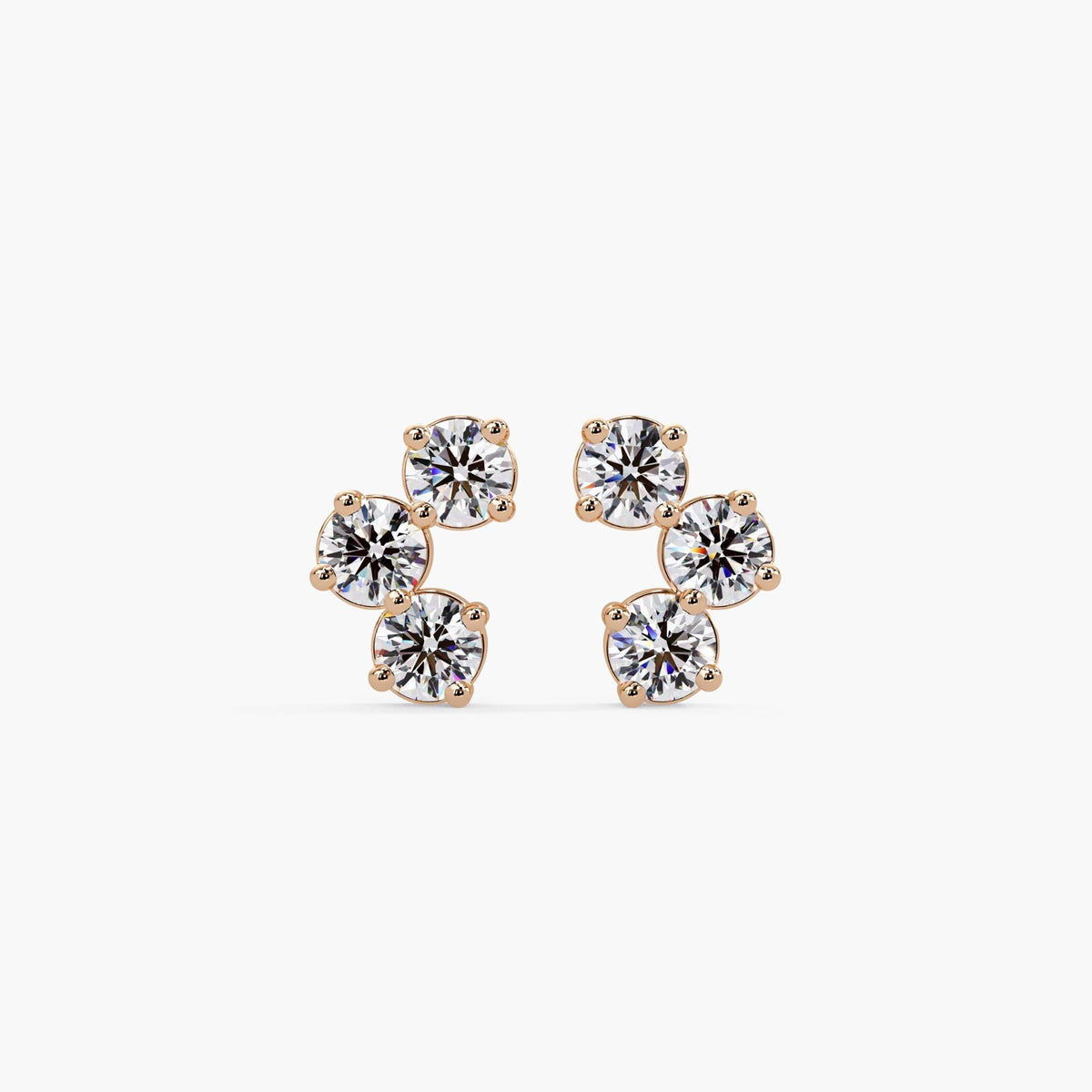 Curved three-stone cluster earrings in 14K rose gold featuring round lab-grown diamonds in a minimalist prong setting.