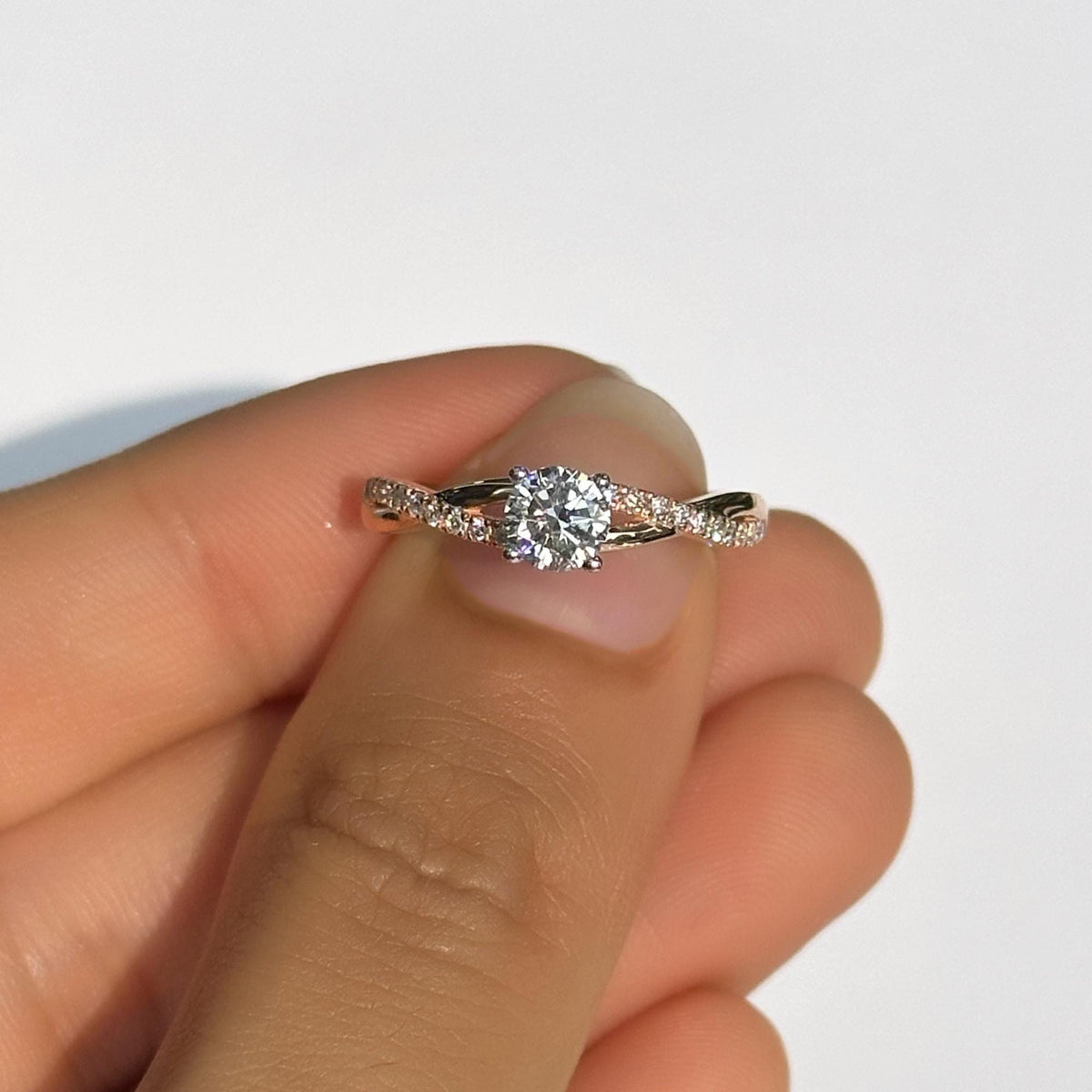 18K gold twisted band engagement ring featuring a round brilliant lab-grown diamond in a 4 prong setting. This braided, half eternity ring is minimalist and dainty making it a perfect wedding, anniversary, or promise ring. A thoughtful milestone gift for her or for wife, handcrafted in ethical gold and ideal for stacking.