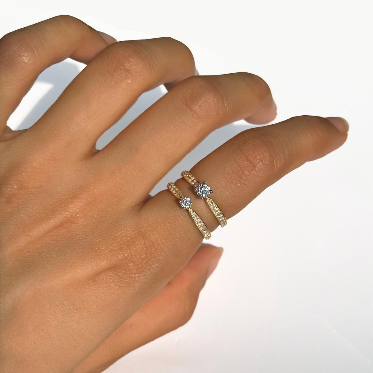 18K gold half eternity solitaire rings with round lab-grown diamonds and channel-set pavé bands, shown together for size reference and styling inspiration.