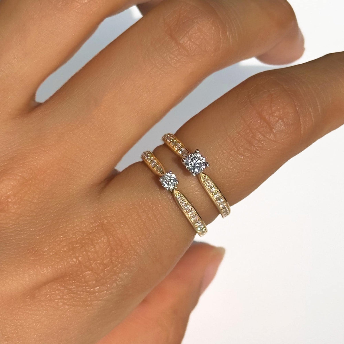 18K gold channel-set solitaire rings with round lab-grown diamonds, shown side by side for size comparison between 0.10 ct and 0.20 ct center stones. Perfect as promise rings, engagement rings, anniversary gifts, or meaningful stacking rings for her.