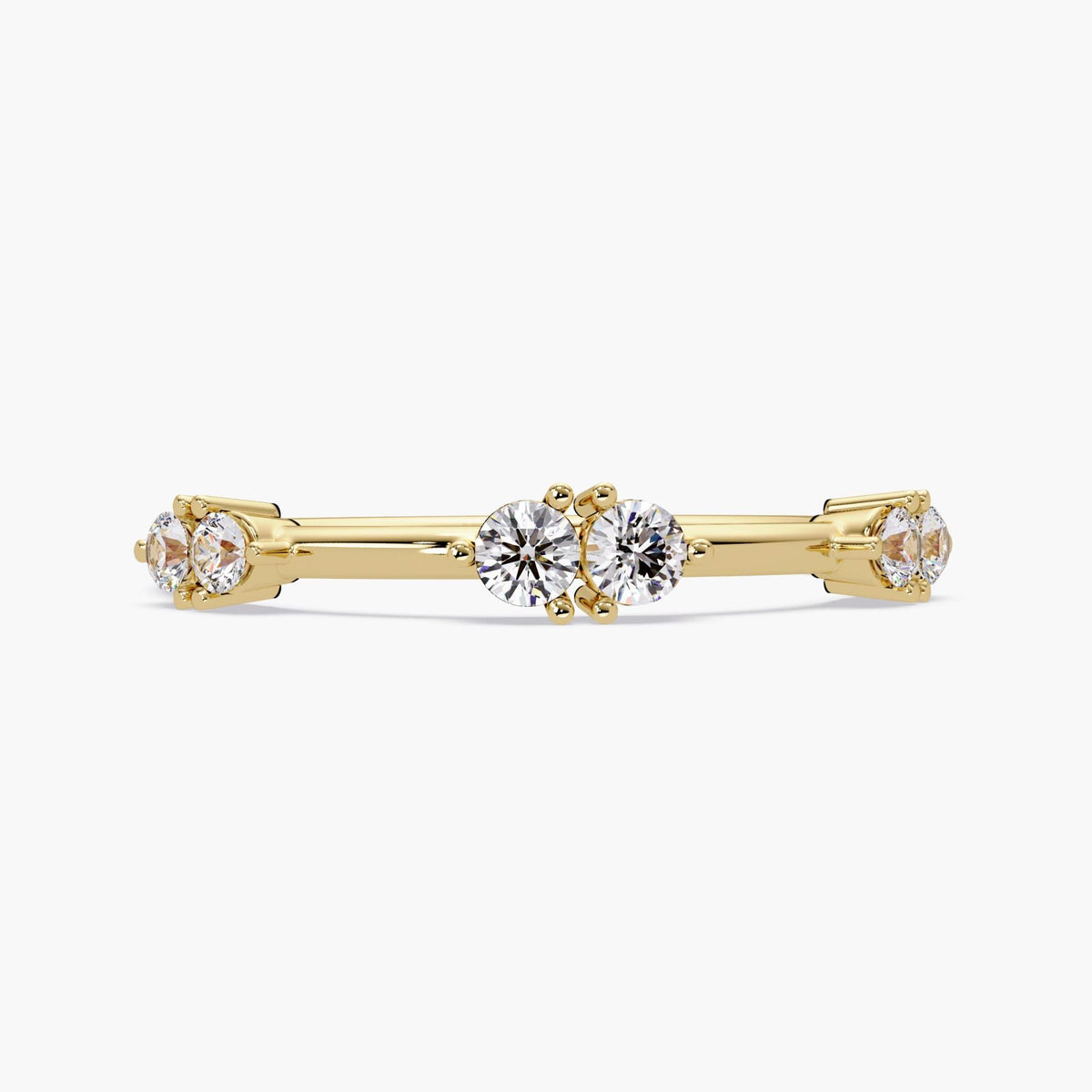 14K yellow gold stacking ring featuring six natural round diamonds set in three pairs. Each diamond pair is prong-set spaced layout along a high-polish solid gold band. The band is ultra-thin and dainty, ideal for layering or wearing solo as a minimalist statement. Perfect for milestone gifting or everyday sparkle.