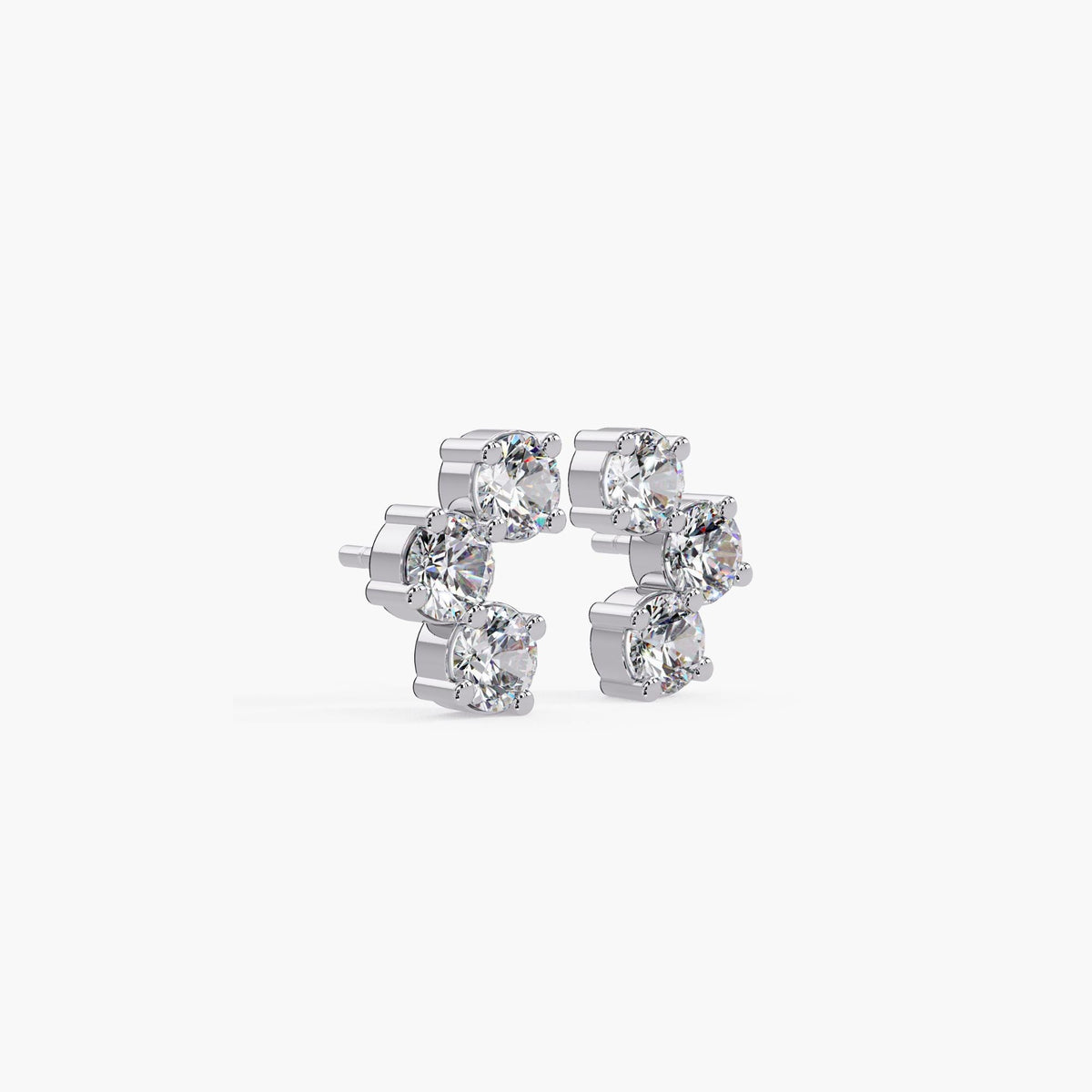 14K white gold three-stone curved stud earrings with prong-set round lab-grown diamonds.