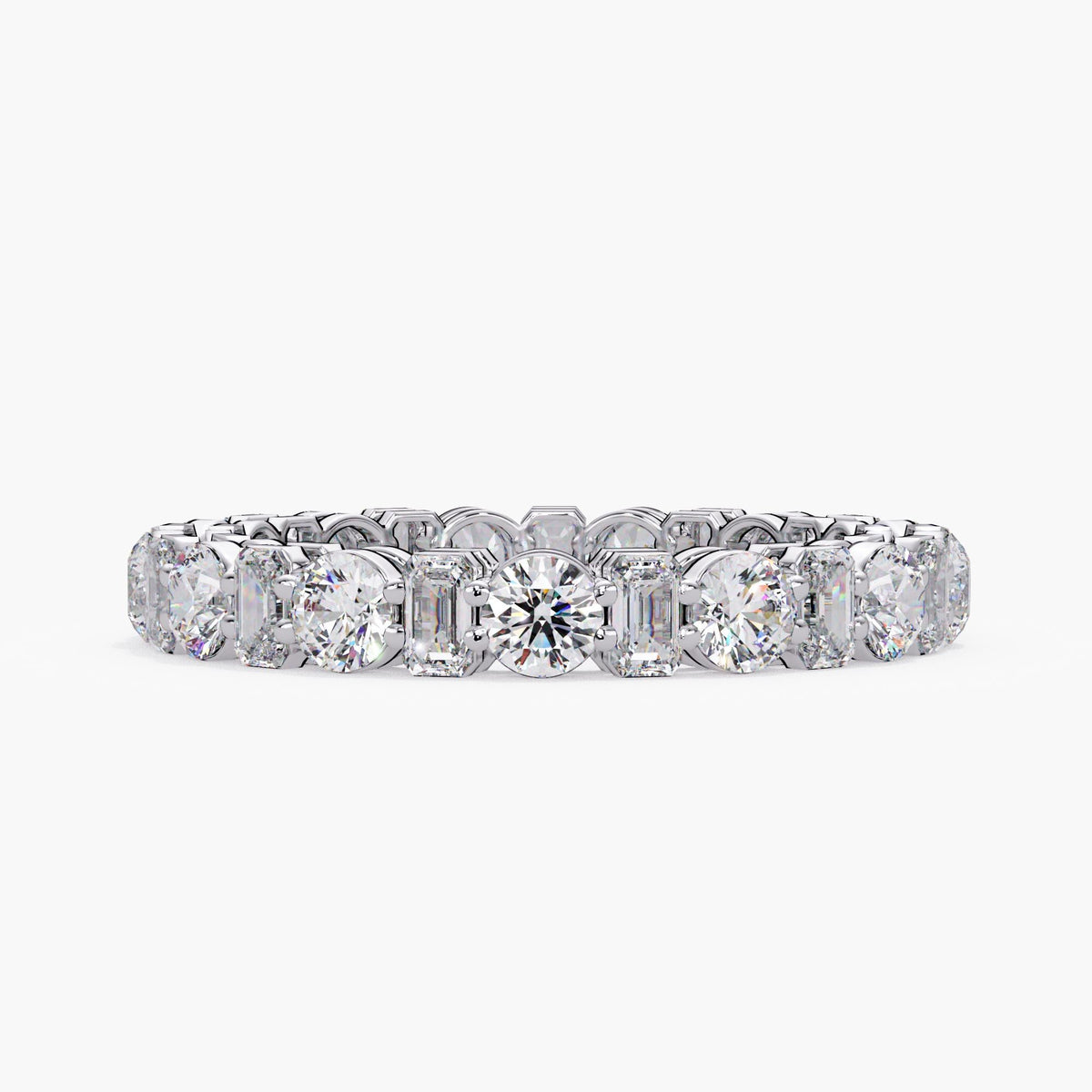 14K white gold eternity ring set with alternating round and emerald-cut lab-grown diamonds in prong settings.