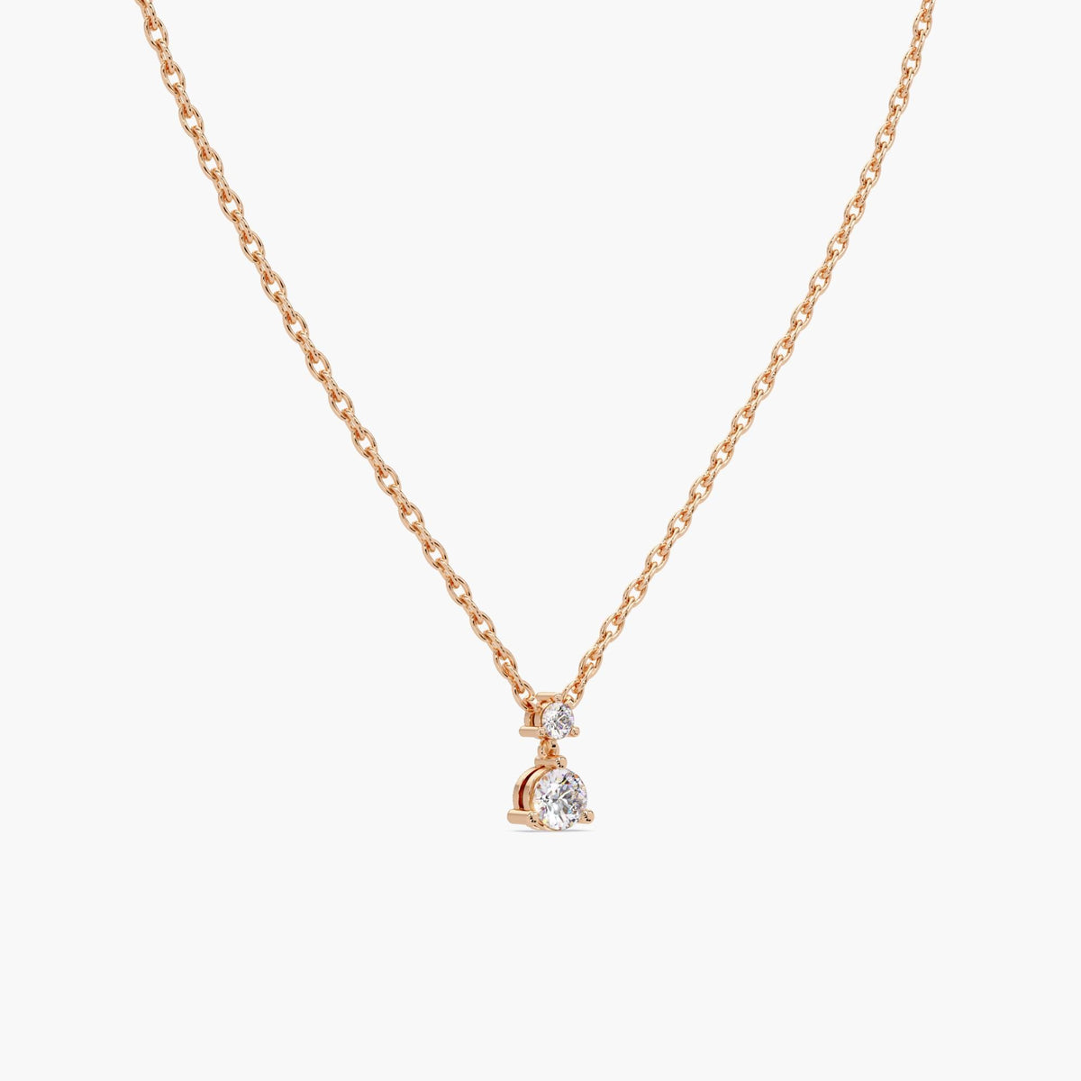 Floating two-stone lab diamond pendant on rose gold cable chain with prong setting