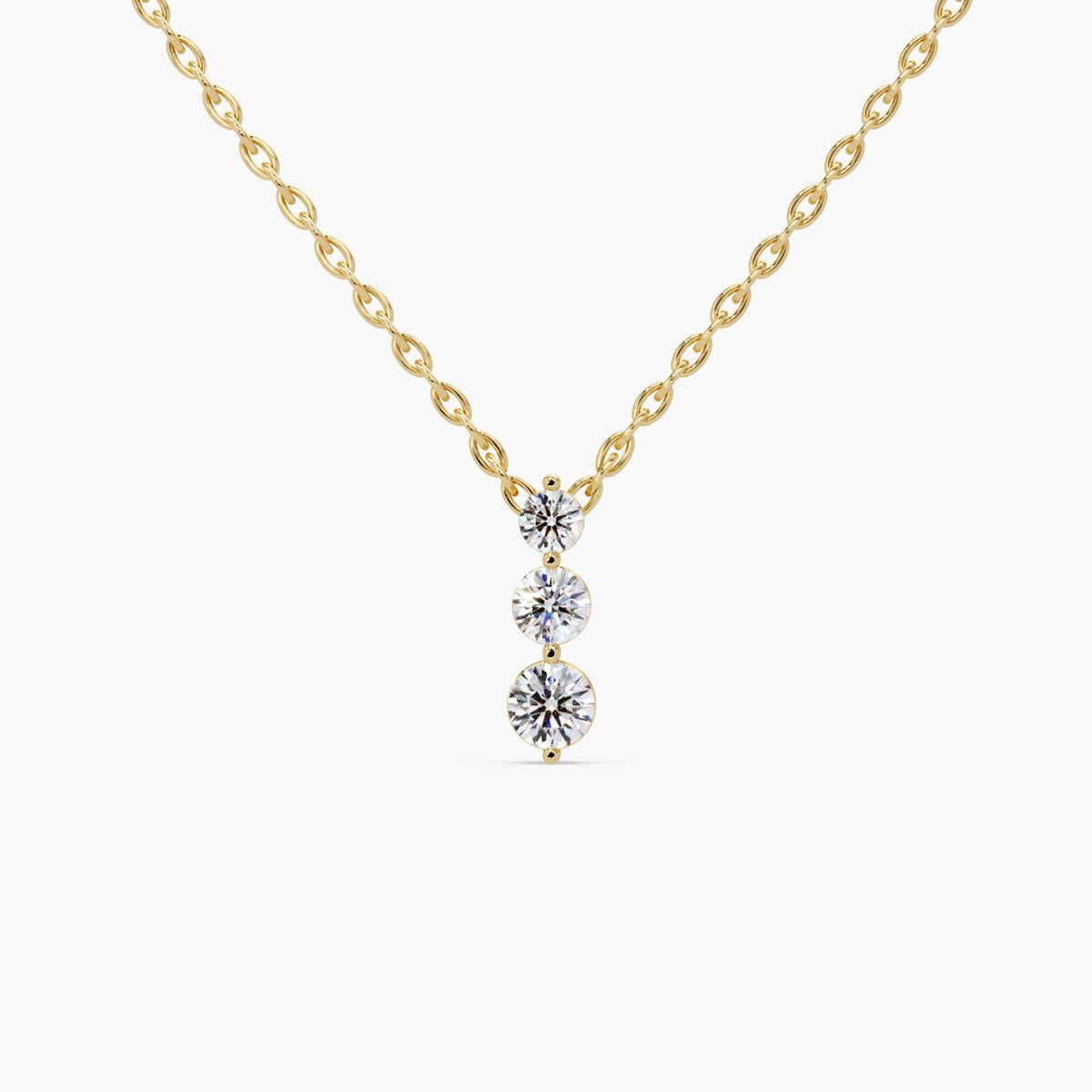 14K yellow gold necklace with three round lab-grown diamonds in a vertical drop pendant, graduating in size from top to bottom, on a 1mm cable chain