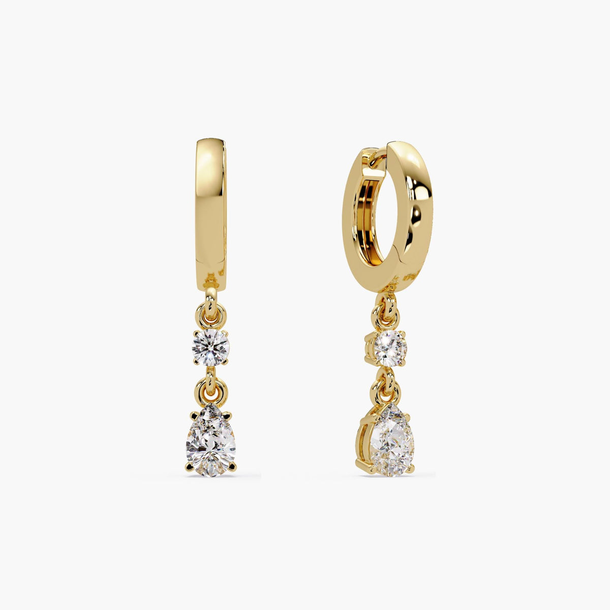 14K yellow gold huggie earrings featuring lab-grown round and pear-shaped diamonds in a prong setting. Each earring has a 3mm round diamond above a 6x4mm pear diamond, suspended from a high-polish hinged hoop.