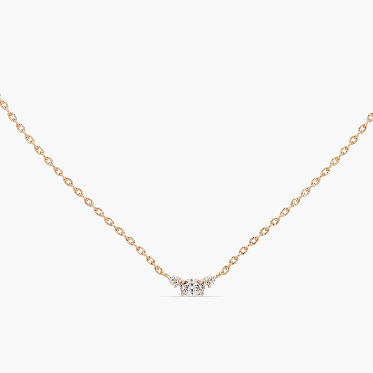 14K rose gold dainty three stone necklace with oval lab-grown diamond center and pear side accents, delicate diamond pendant on fine chain designed for everyday wear, romantic anniversary gift, or minimalist layering necklace for women.