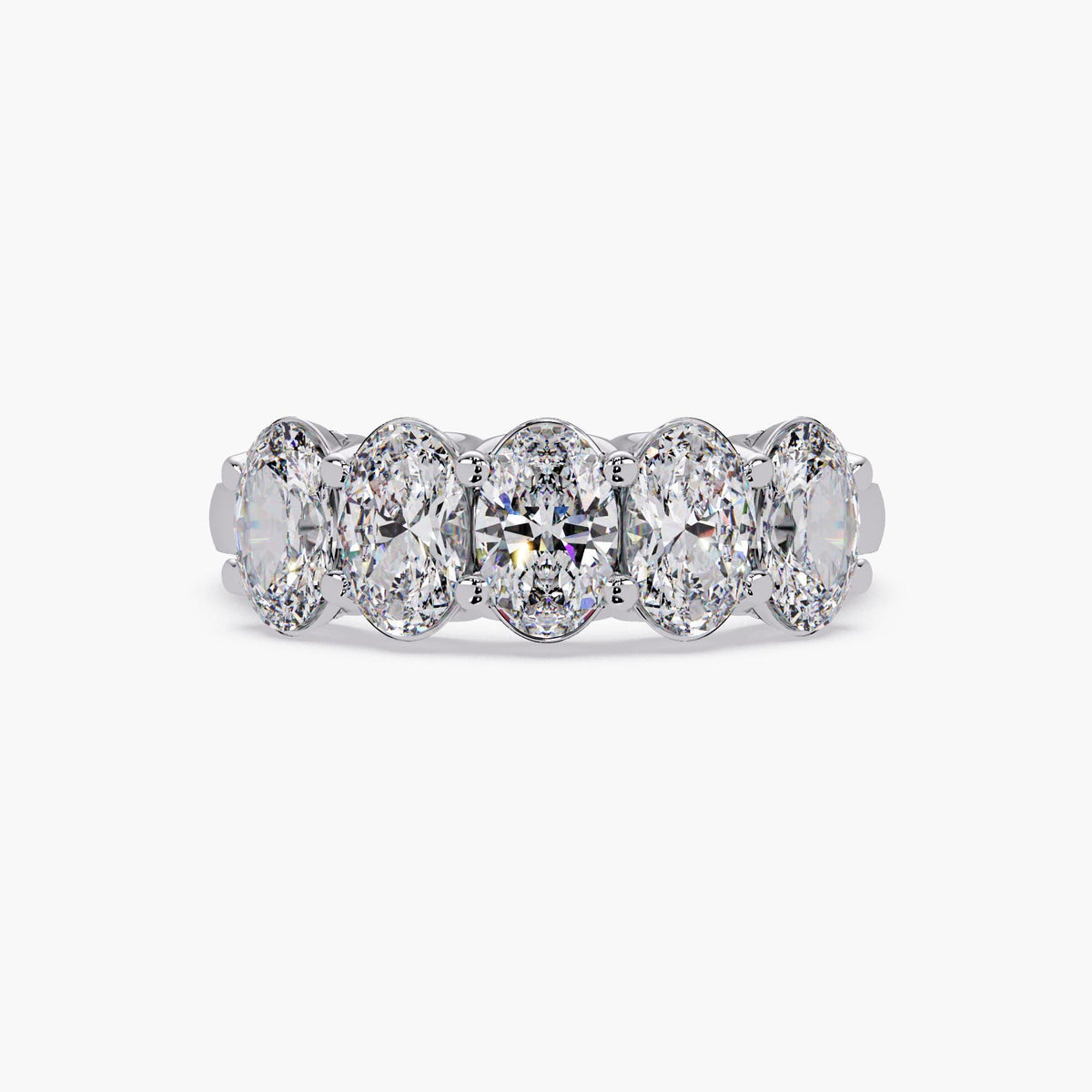 Five stone oval diamond half eternity band in 14K yellow gold shown on hand, highlighting full finger coverage and brilliant sparkle for everyday or bridal wear.