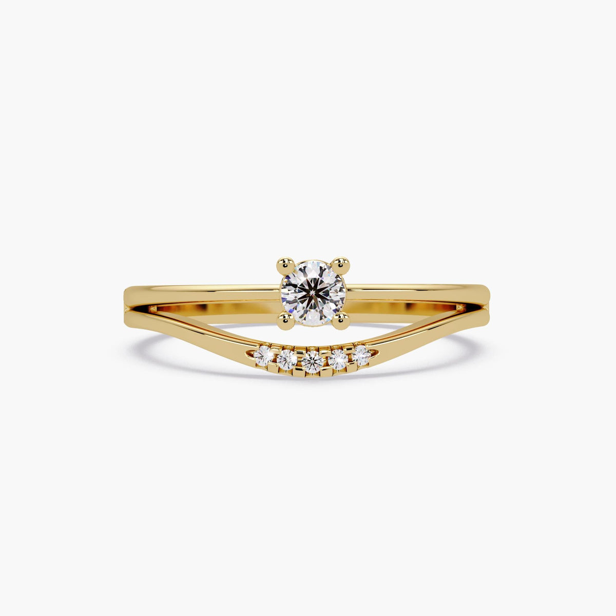 A 14K yellow gold natural diamond bridal set featuring a round solitaire engagement ring set with prongs, perfectly paired with a curved contour wedding band enhancer embellished with five small pave-set diamonds.