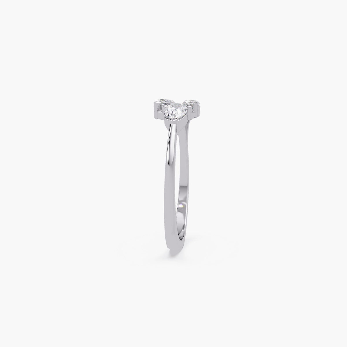 white gold three-stone diamond ring, highlighting open collet setting with pear and marquise-shaped lab-grown stones.