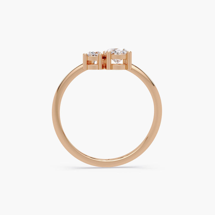 rose gold Toi et Moi ring with oval and pear lab-grown diamonds in open prong settings on a slim round band