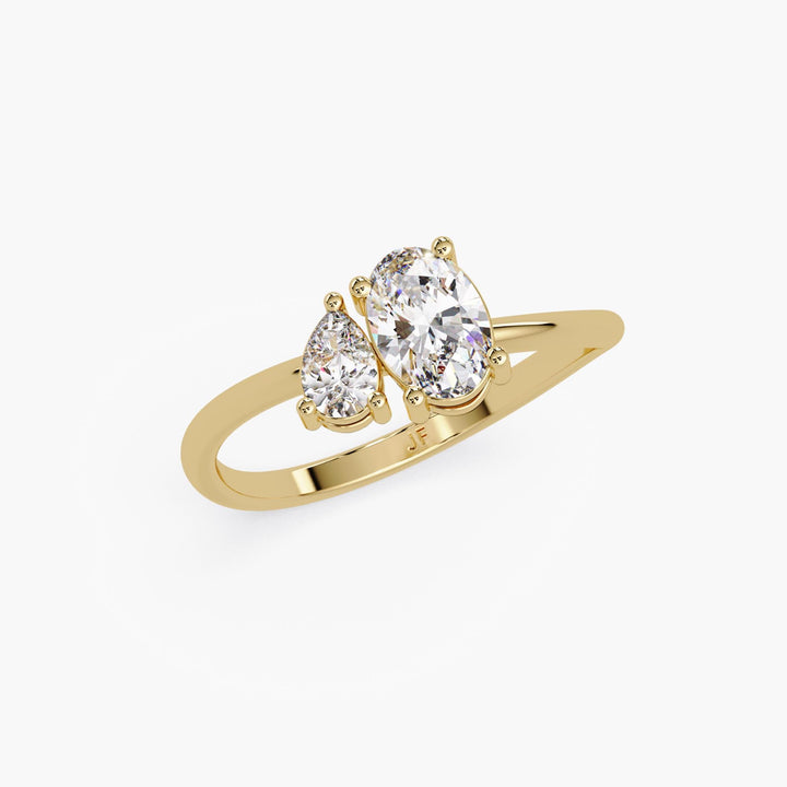 14K yellow gold Toi et Moi ring with oval and pear lab-grown diamonds on a curved band