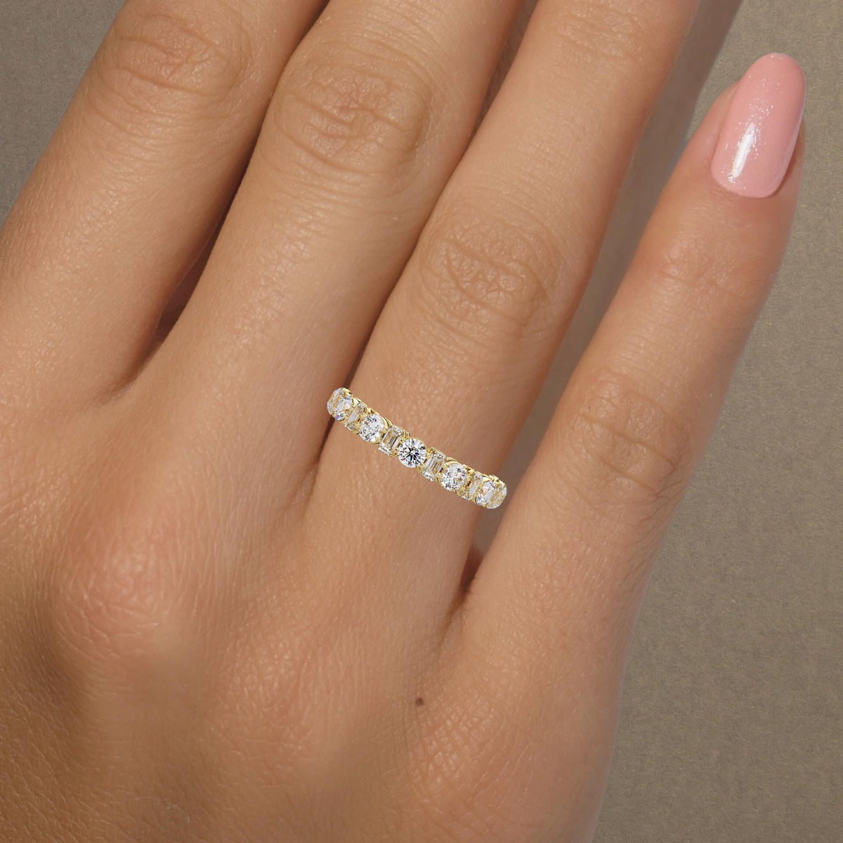 14K yellow gold lab-grown diamond eternity band with alternating round and emerald-cut stones in prong settings. Perfect as a wedding band, anniversary ring, or stacking ring.