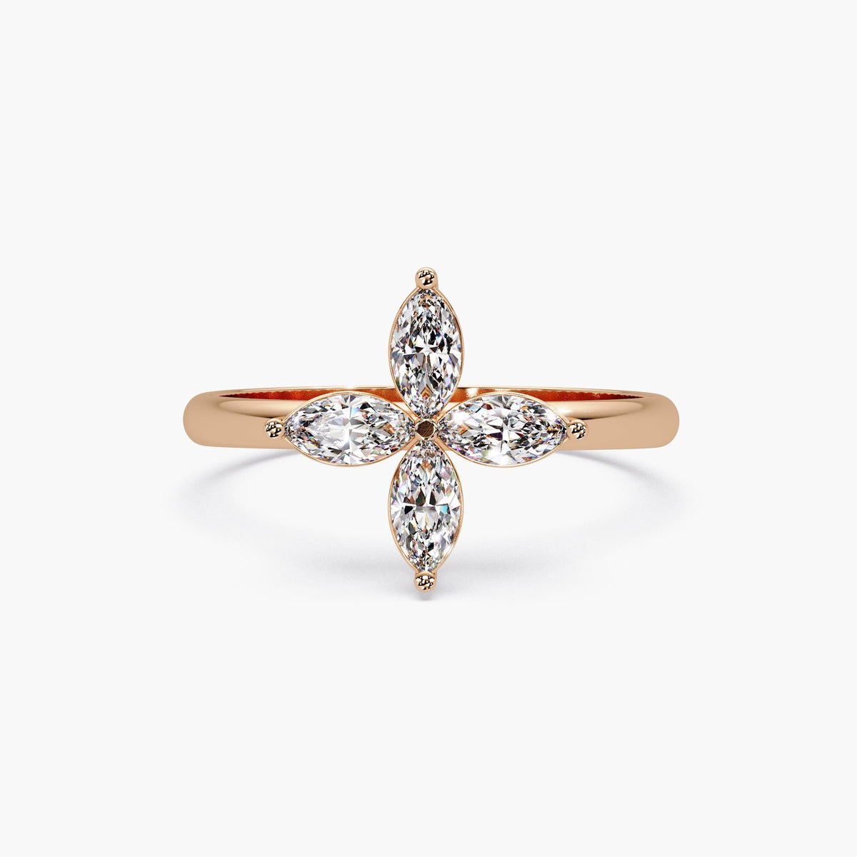 Rose gold diamond clover ring with four marquise diamonds in a floral cross design on a polished solid gold band