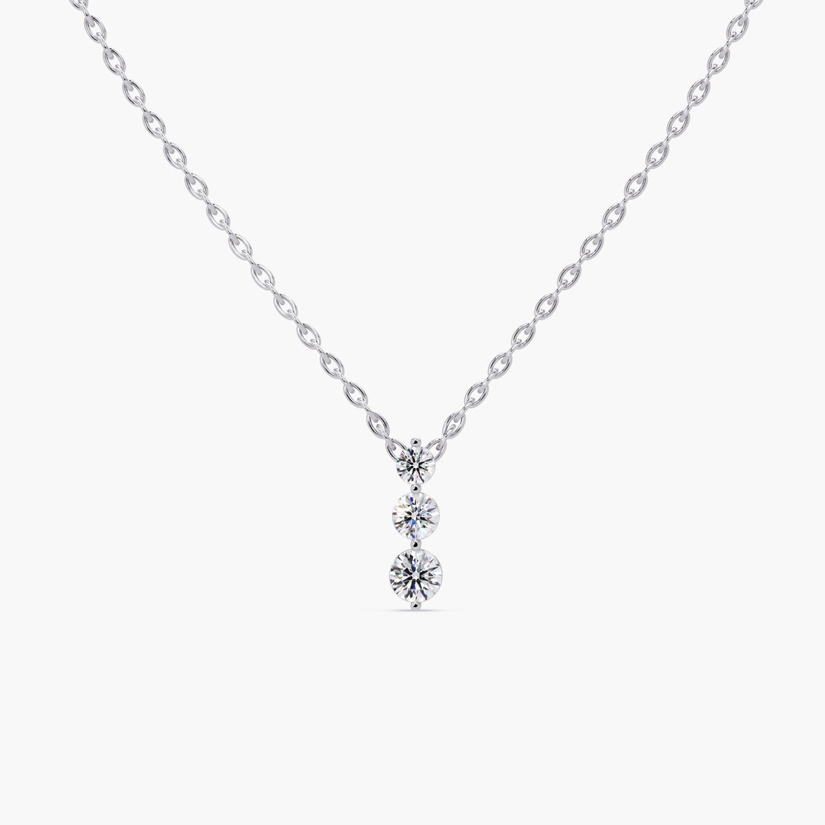 14K gold three-stone necklace featuring lab-grown diamonds in a vertical prong-set pendant on a fine gold chain