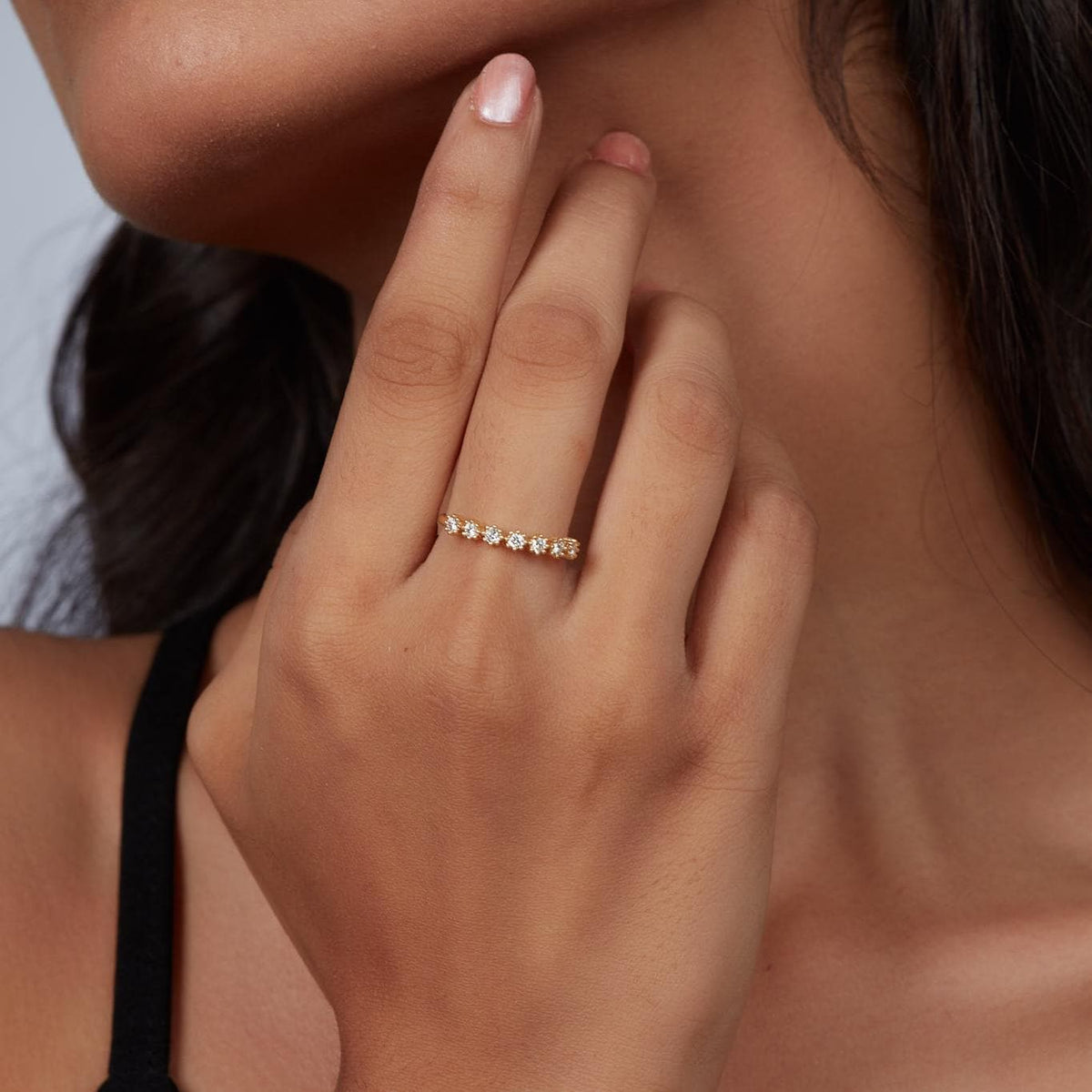 14K gold floral diamond ring worn on a woman's hand, showcasing seven round lab-grown diamonds in a petal-inspired prong setting. The dainty gold band sparkles with a nature-inspired, stackable design — ideal as a wedding band, birthday gift, or everyday fine jewelry.