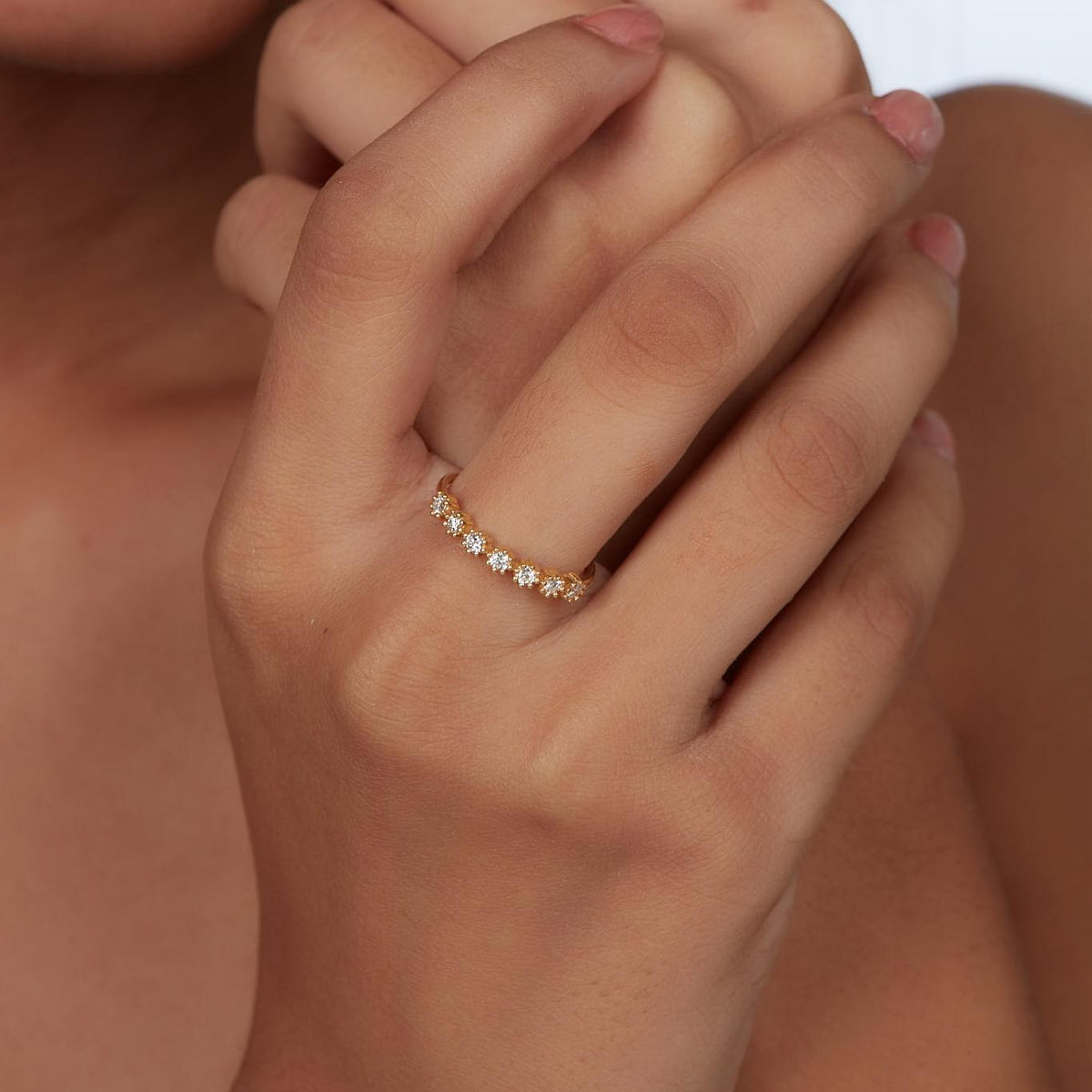 14K yellow gold daisy-inspired diamond ring worn on the hand, featuring seven round lab-grown diamonds in a floral prong setting. A delicate and stackable band perfect for everyday wear, nature lovers, or meaningful gifting.
