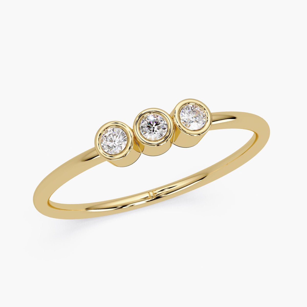 14k gold three stone diamond ring with bezel set natural diamonds.