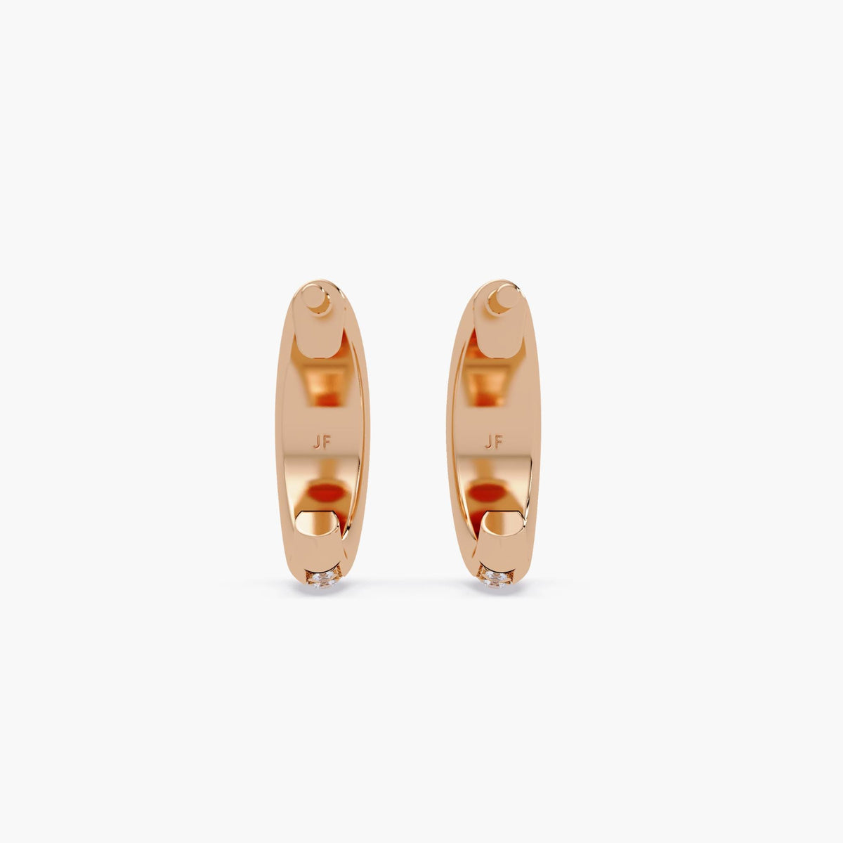 14K rose gold dome huggie earrings, showing smooth polished finish with JF hallmark and channel set diamonds at the base.