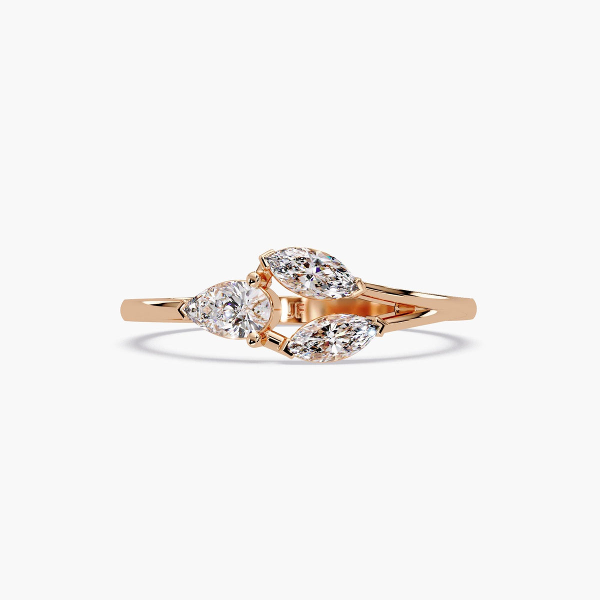 Three-stone diamond ring in 14K rose gold featuring one pear-shaped and two marquise-cut lab-grown diamonds in an open band setting. The floral-inspired design showcases a curved bypass style with a polished pink gold band