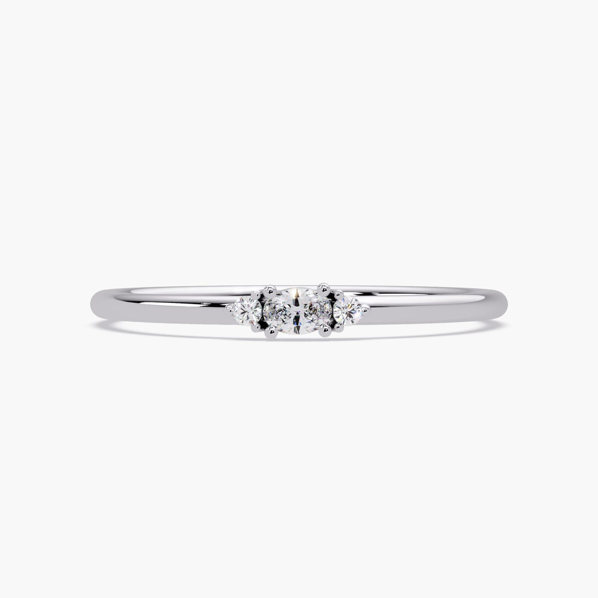 14K white gold diamond ring with a center oval-cut lab-grown diamond and two round side stones on a polished thin band