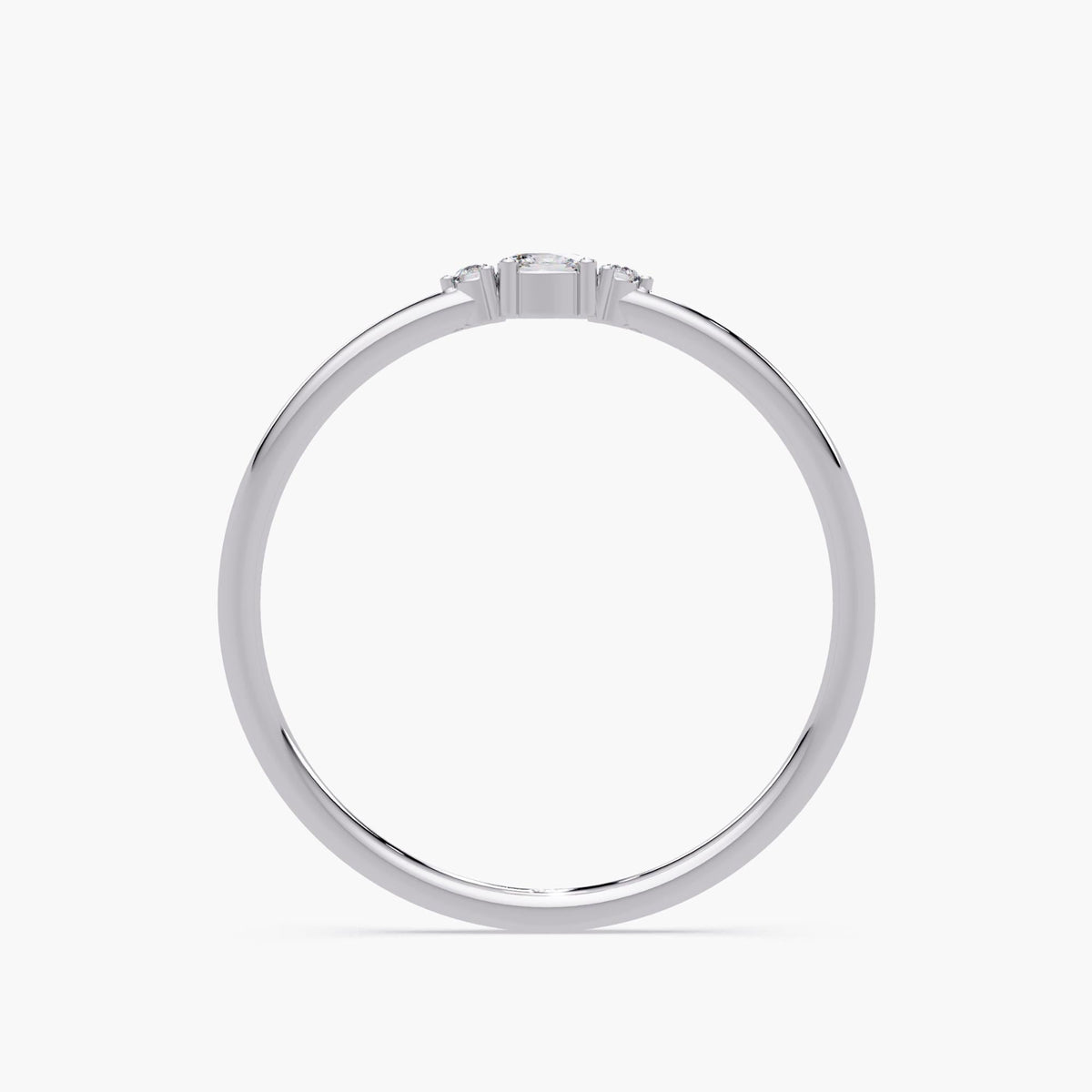 14K white gold ring with a slim band and low-set three-stone diamond setting, showing the height and prong structure of the ring.