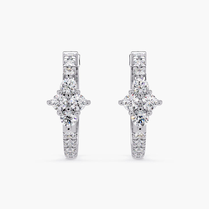 A pair of 14K white gold hoop earrings on a white background, featuring a floral cluster of lab-grown diamonds at the front. The lever-back closure is visible.