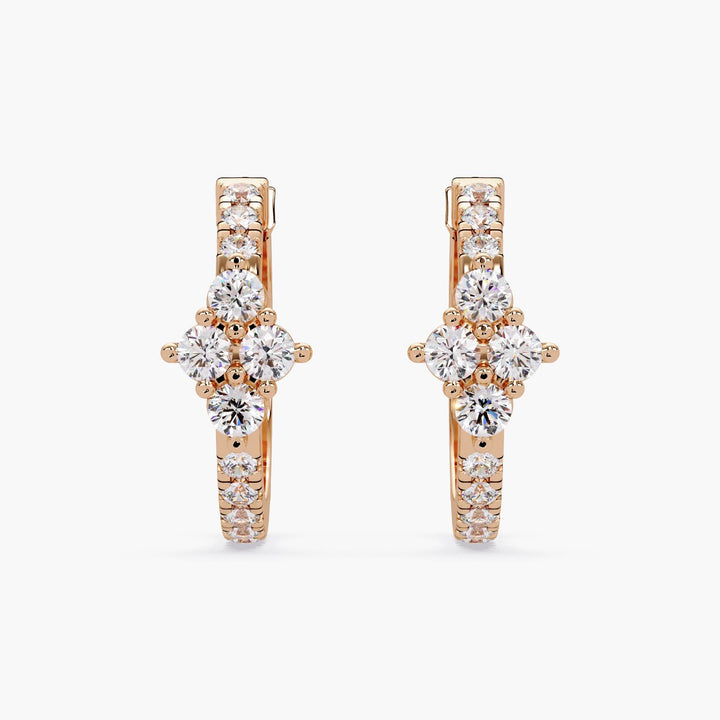 A pair of 14K rose gold hoop earrings on a white background, featuring a floral cluster of lab-grown diamonds at the front. The lever-back closure is visible.