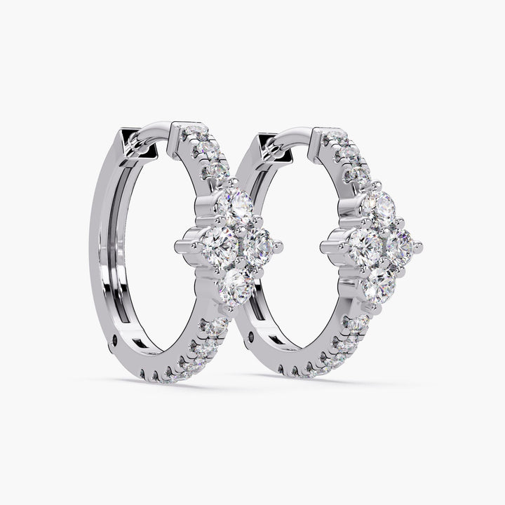 A pair of 14K white gold hoop earrings on a white background, featuring a floral cluster of lab-grown diamonds at the front. The lever-back closure is visible.