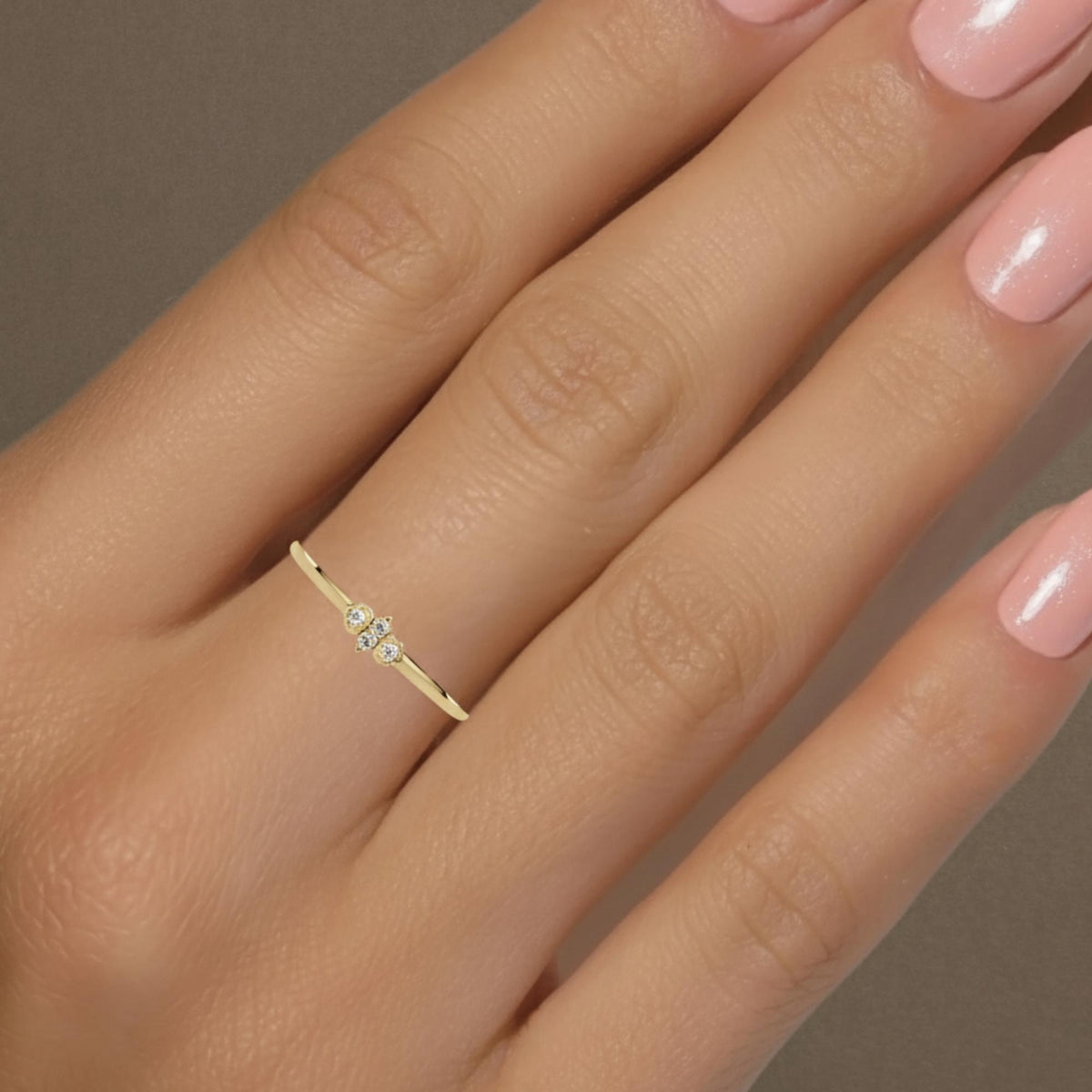 Modern stacking ring with diamonds in a slim gold band.